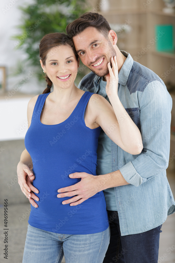 Fototapeta premium man hugging the belly of pregnant woman
