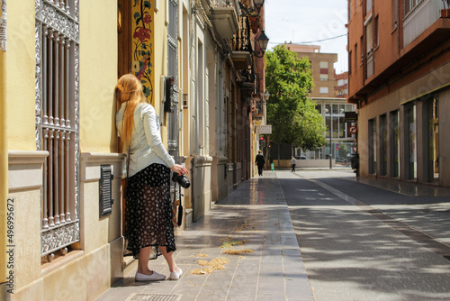 Tourist blonde woman walking in the city with a camera © Jose D´Alessandro