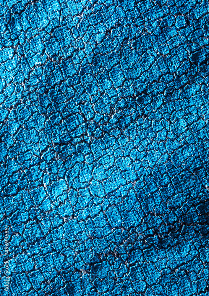 Naklejka premium Cracked blue paint on fabric as an abstract background.