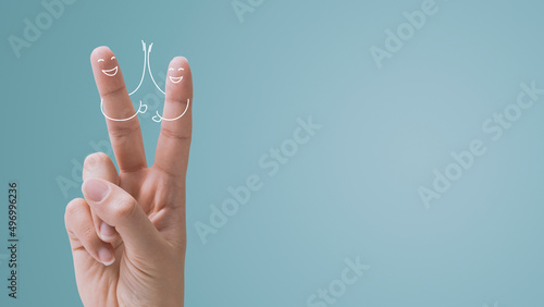 Woman making a V-sign and stick figures photo