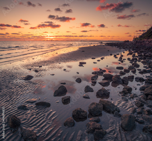 Fototapeta Naklejka Na Ścianę i Meble -  Sunrise Over the Sea with Cloud Reflections