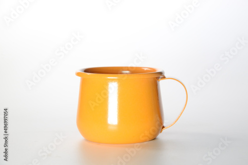 Zinc glass bright orange on a white background. Ideas for mock ups...Blank mock up Empty classic undervest mug with neckline mockup, isolated.
