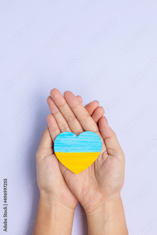 Support for Ukraine in the war with Russia, Hands holding symbol of Heart with flag of Ukraine. Pray, No war, stop war and stand with Ukraine Support for Ukraine in the war with Russia, Hands holding symbol of Heart with flag of Ukraine. Pray, No war, stop war and stand with Ukraine