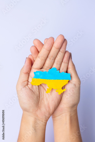 Support for Ukraine in the war with Russia, Hands holding the shape of Ukraine border with color flag. Pray, No war, stop war and stand with Ukraine