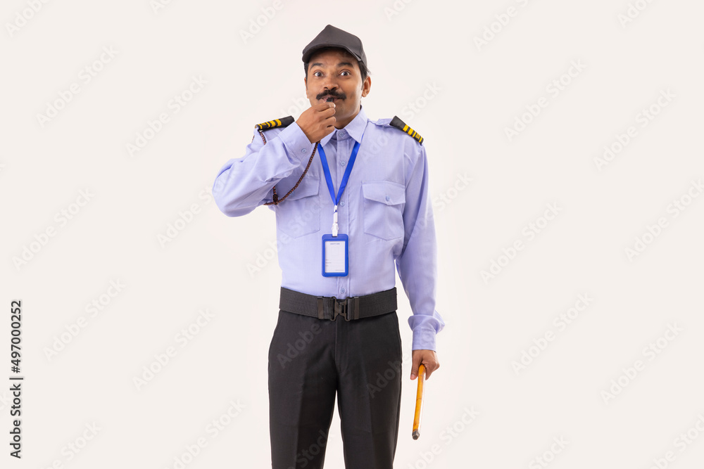 Portrait of Security guard blowing whistle