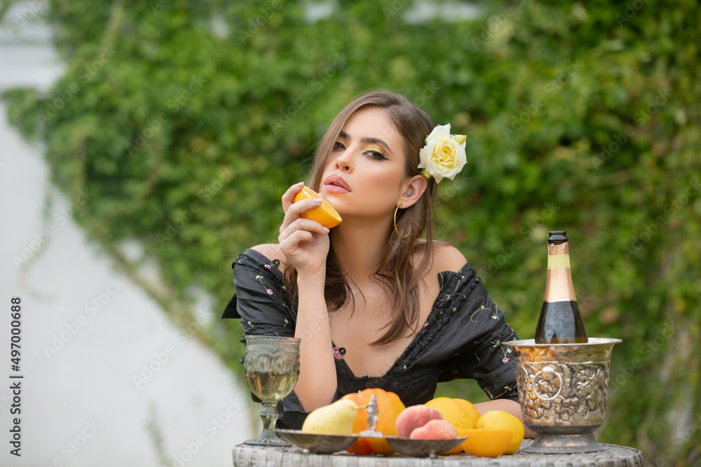 Young sexy woman relaxing and eating fruit outdoor. Exotic summer diet, tropical fruits. Young sexy woman relaxing and eating fruit outdoor. Exotic summer diet, tropical fruits.