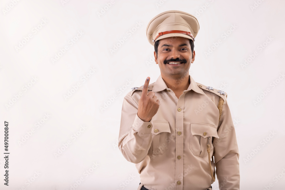 Portrait of policeman standing with voter mark on index Portrait of policeman standing with voter mark on index