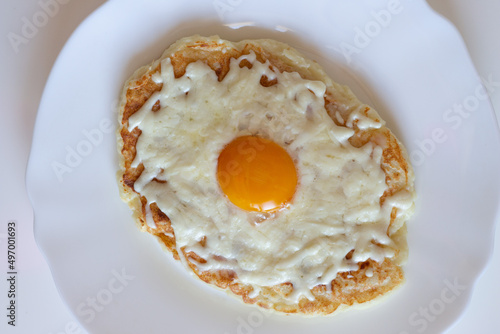 Adjarian khachapuri in a frying pan. Dietary low-calorie khachapuri with cottage cheese dough on a white plate. Proper nutrition. simple breakfast. High quality photo