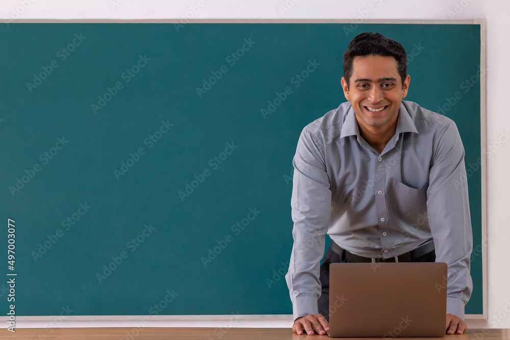 Portrait of a smiling school teacher looking at camera during online class Portrait of a smiling school teacher looking at camera during online class