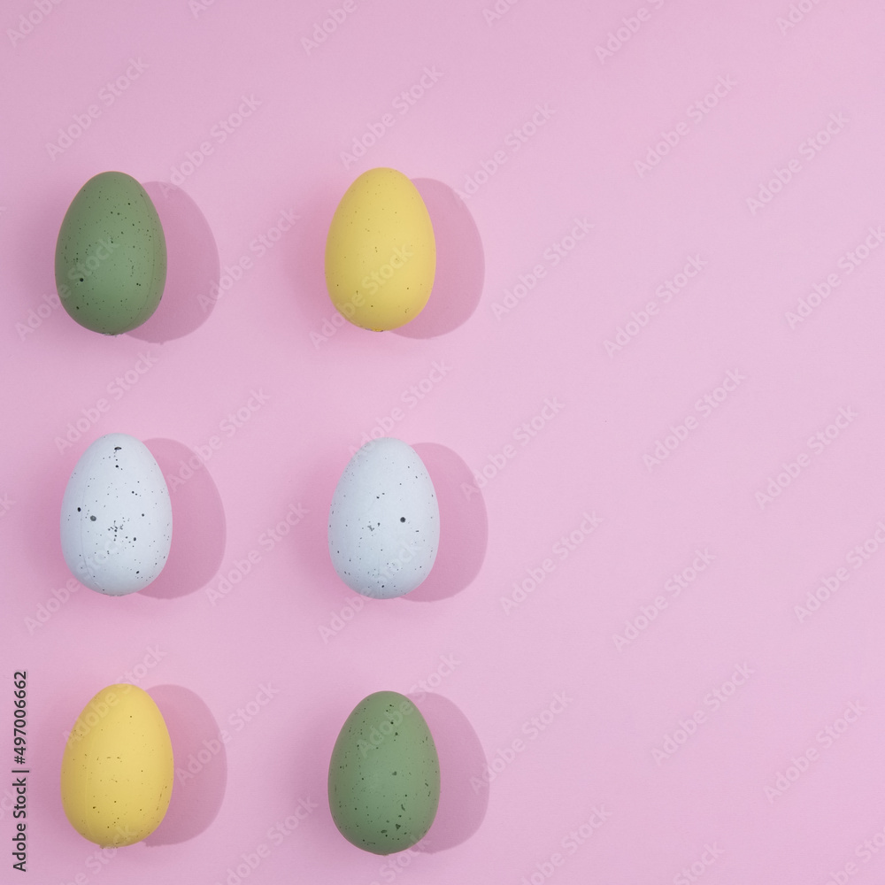 Pattern Easter eggs of different colors with slight shadows on a pink background with copy space. minimal Easter scene.