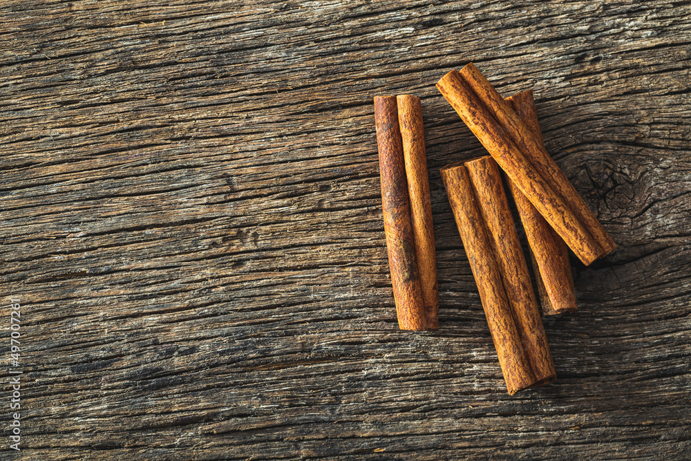 Dry cinnamon sticks on wooden table. Cinnamon spice. Dry cinnamon sticks on wooden table. Cinnamon spice.