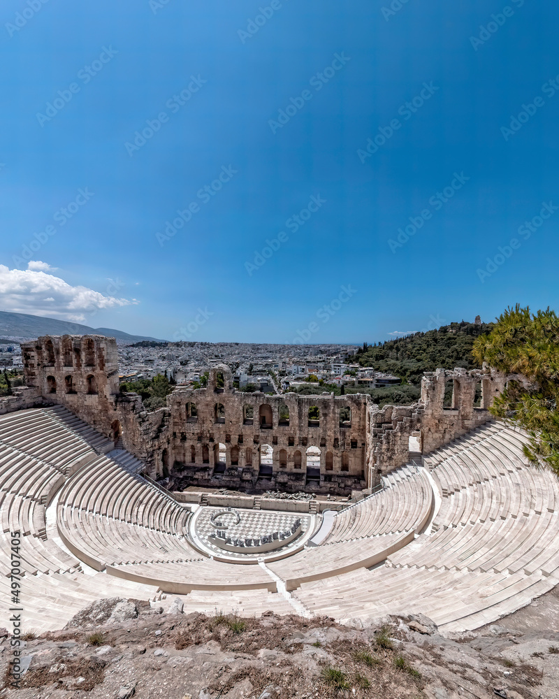 Herodeion ancient theater and Athens city view under crystal clear blue sky, Greece