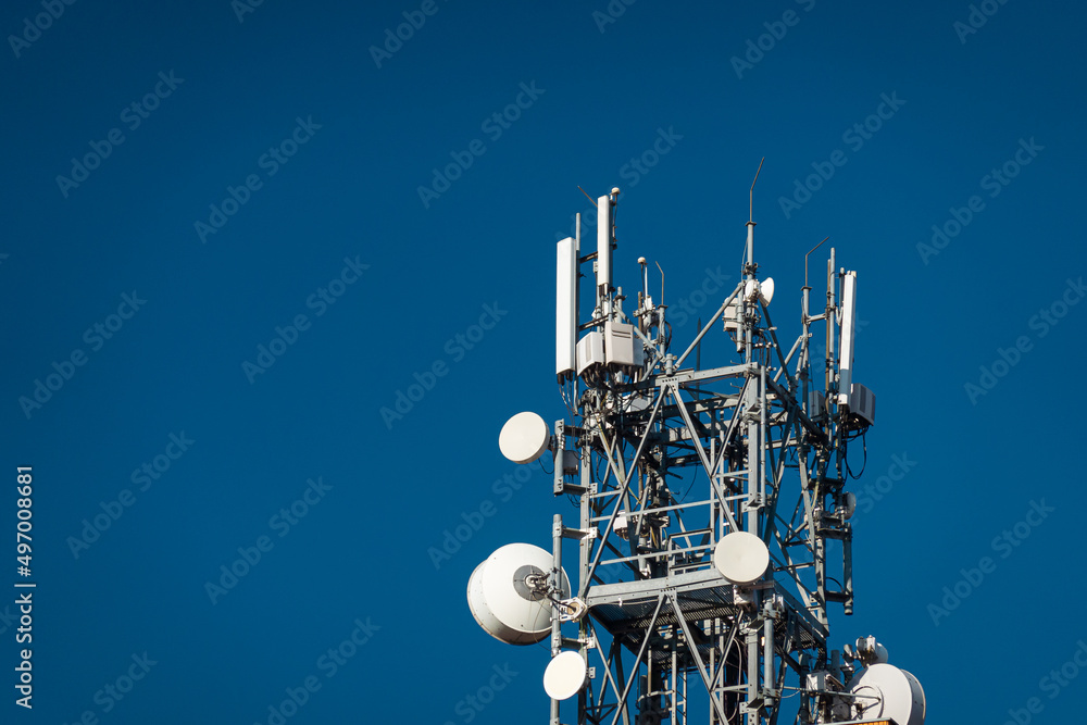Scaffolding with communication GSM and internet antennas against a clear blue sky