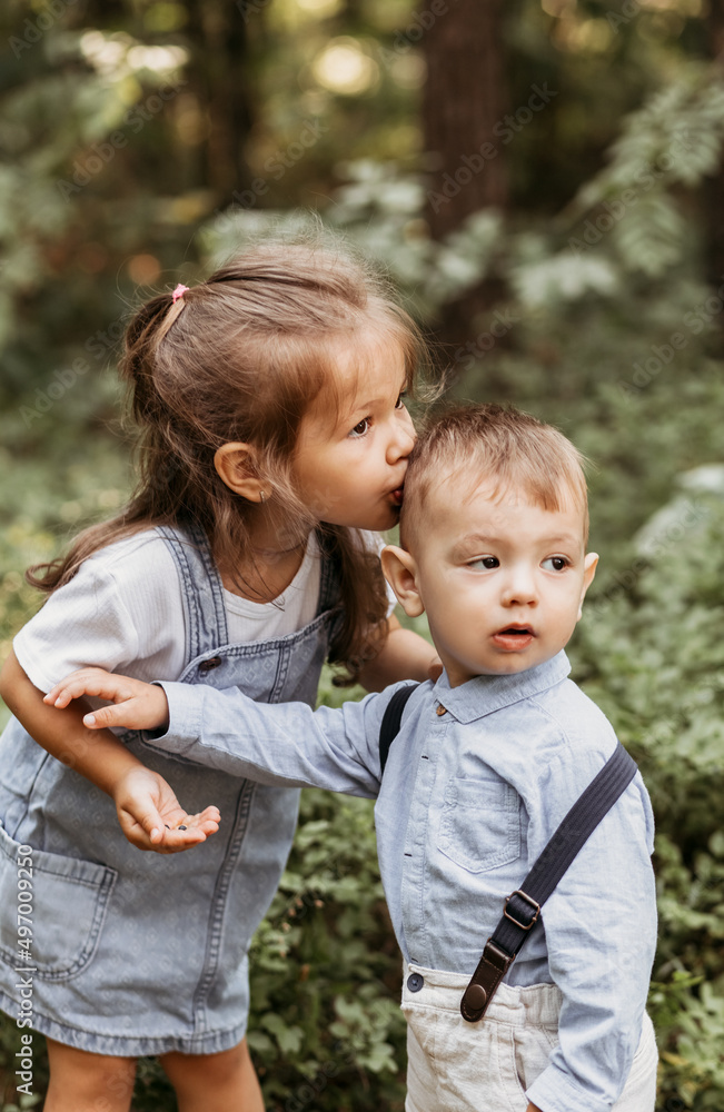 little boy and girl. children walking through the park. Portrait of happy kids on a bright sunny day. Friendship. Summer holidays. little boy and girl. children walking through the park. Portrait of happy kids on a bright sunny day. Friendship. Summer holidays.
