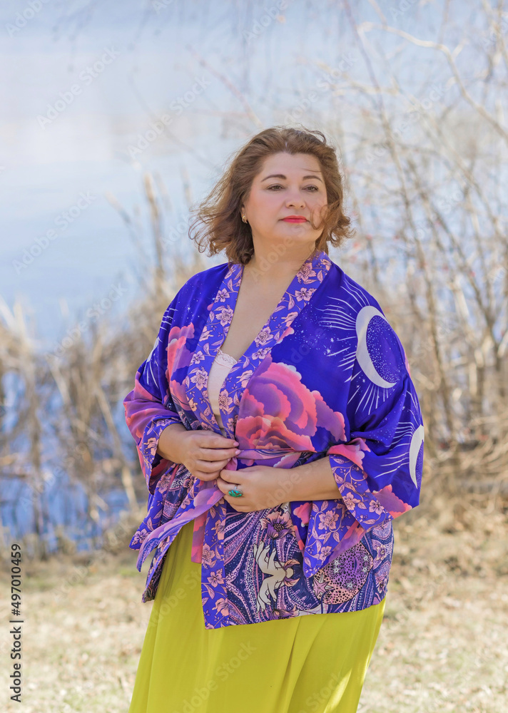Plus size lady in yellow skirt and Boho ethnic esoteric cardigan. Fashionable for women, new collection 