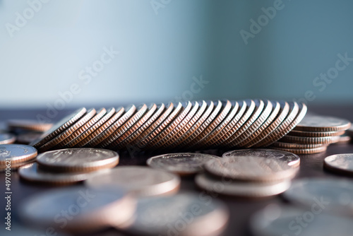 Stack coin on wooden background. pile thai cash and blur floor bank account. plan investment income for 2023 new year. business or finance concept.