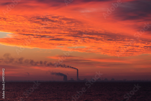 
View from sunrise or sunset
Zaporozhye nuclear power plant in Energodar, Ukraine, close-up from the embankment of Nikopol photo