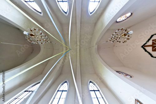 interior dome and looking up into a old gothic or baroque catholic church ceiling with columns