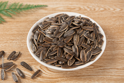 Sunflower seeds in plate on table