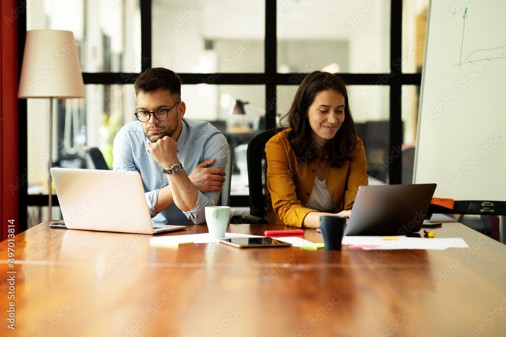 Colleagues in office. Businesswoman and businessman working together. Colleagues in office. Businesswoman and businessman working together.
