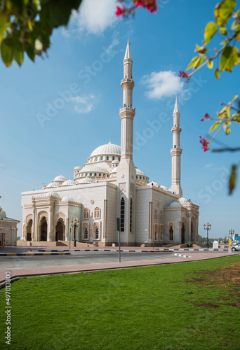 Beautiful Al Noor Mosque located at Sharjah corniche. A view of a Masjid against blue sky.