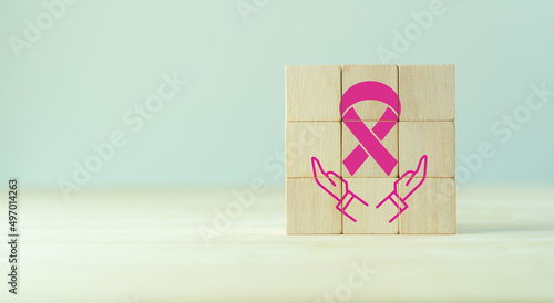  Pink ribbon, breast cancer awareness concept. Symbol of national breast cancer awareness month in october. Healthcare, international women day and world cancer day. Wooden cubes with pink ribbon icon