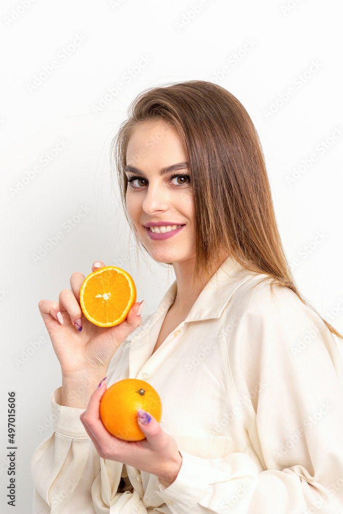 Young Caucasian smiling woman with slices orange over isolated white background Young Caucasian smiling woman with slices orange over isolated white background