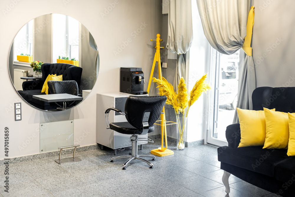 Modern small bright hair and beauty salon in black and yellow colors with  gray walls and floor and black sofa with yellow cushions Stock Photo |  Adobe Stock