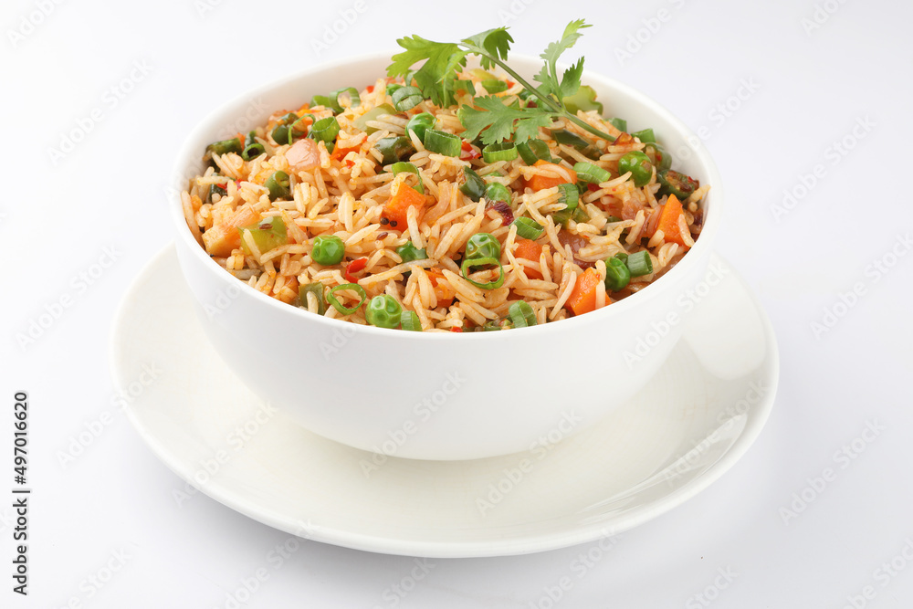 Schezwan Fried Rice is a popular indo-chinese food served in a plate or bowl with authentic sausages. selective focus