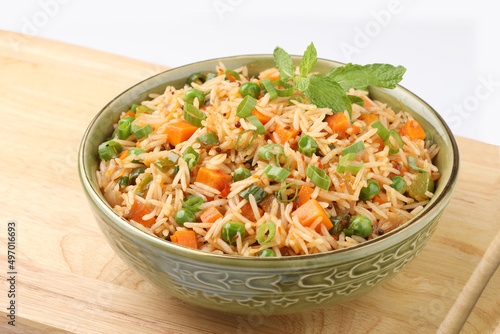 Schezwan Fried Rice is a popular indo-chinese food served in a plate or bowl with authentic sausages. selective focus