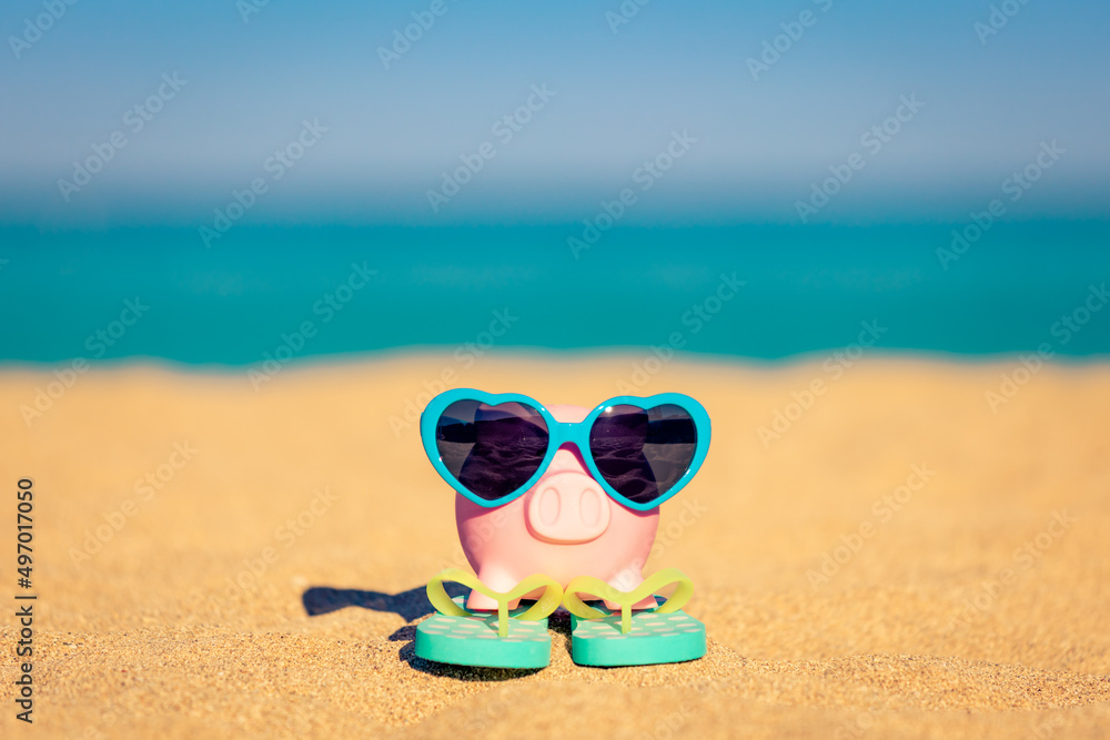 Piggybank on the beach in summer Piggybank on the beach in summer
