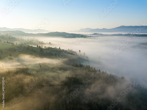 Morning mist in Ukrainian Carpathian mountains. Aerial drone view.