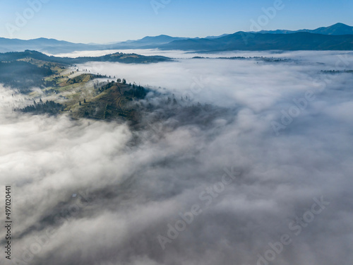 Morning mist in Ukrainian Carpathian mountains. Aerial drone view.
