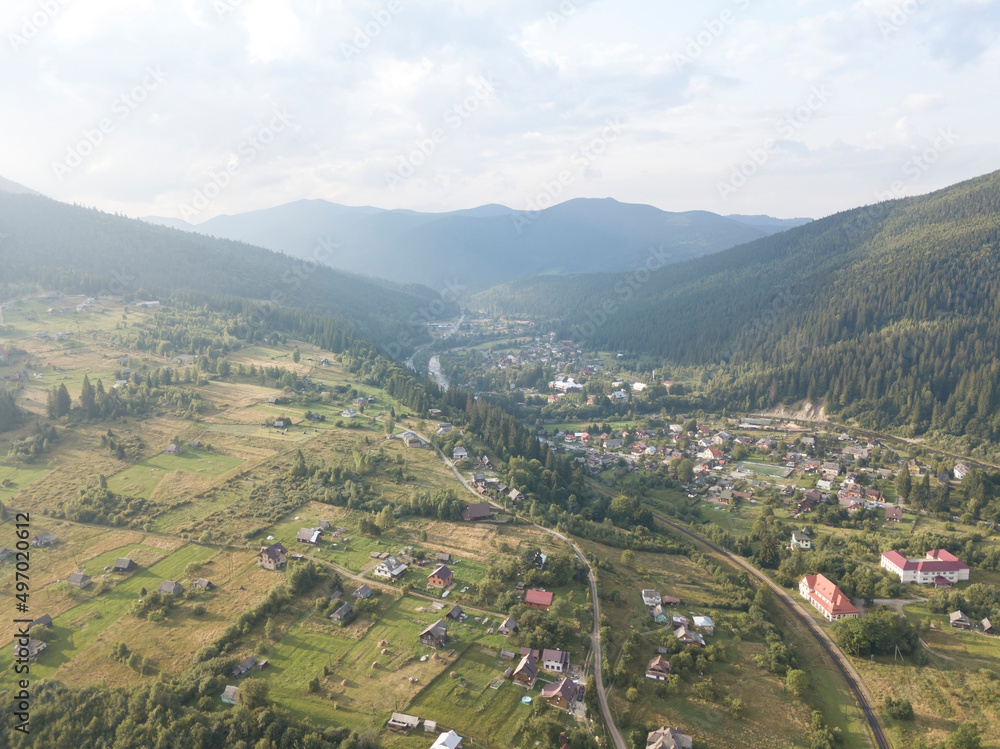Fototapeta premium Green mountains of Ukrainian Carpathians in summer. Coniferous trees on the slopes. Aerial drone view.