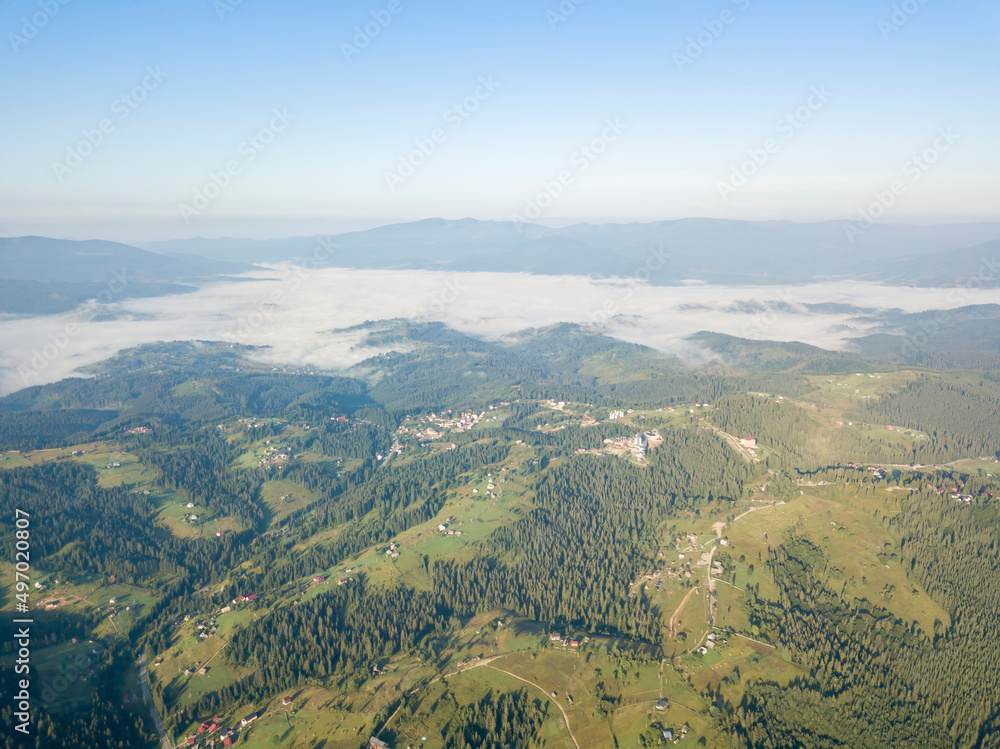 Obraz premium High flight in the mountains of the Ukrainian Carpathians. Fog in the valley. Aerial drone view.