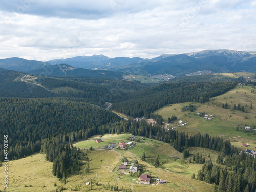 Green mountains of Ukrainian Carpathians in summer. Coniferous trees on the slopes. Aerial drone view.