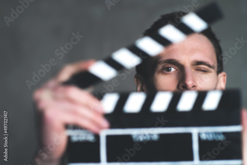 Foto Man is holding clapperboard or clipboard in hands
