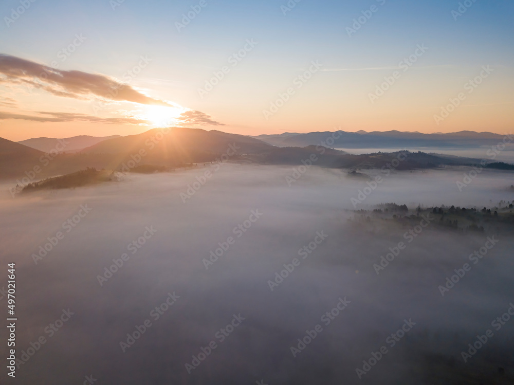 Sunrise over the fog in the Ukrainian Carpathians. Aerial drone view. Sunrise over the fog in the Ukrainian Carpathians. Aerial drone view.