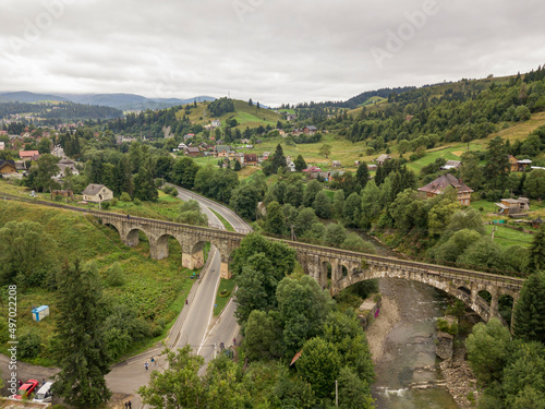 Old railway bridge in the mountains. Ukrainian Carpathians. Aerial drone view.