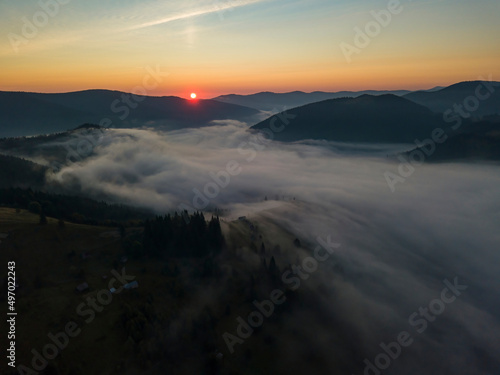 Sunrise over the fog in the Ukrainian Carpathians. Aerial drone view.