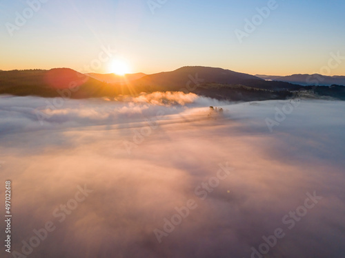 Sunrise over the fog in the Ukrainian Carpathians. Aerial drone view. © Sergey