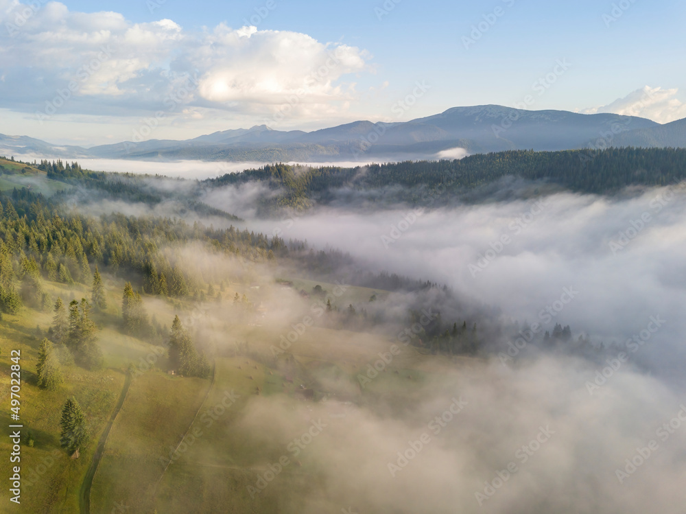 Green mountains of the Ukrainian Carpathians in the morning fog. Aerial drone view.
