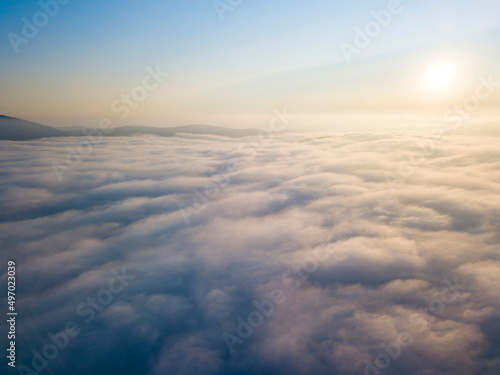 High flight above the clouds. Aerial drone view.