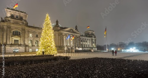 4k winter time lapse of the german parliament building. Snow falling photo