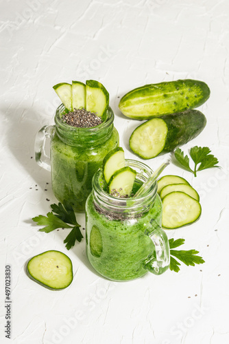 Green smoothie with cucumber in a glass jar. Fresh ripe vegetables, greens, and chia seeds