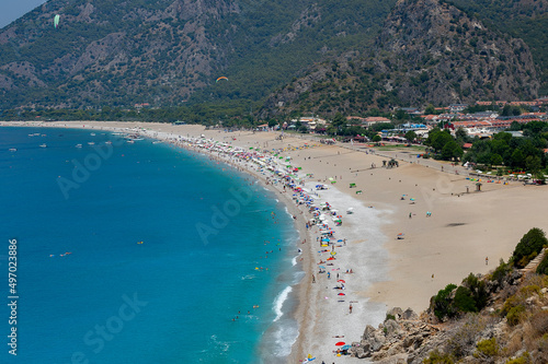 Amazing aerial view of Butterfly Valley in Fethiye Turkey. Summer landscape with mountains, green forest, azure water, sandy beach and blue sky in bright sunny day. Travel background. Top view. Nature © Birol