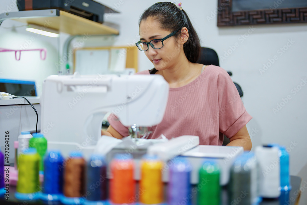 Embroidery, handicrafts, hobbies, SME business, family business, Portrait of Asian female designers are doing by designing patterns using automatic embroidery machines by customer order. Embroidery, handicrafts, hobbies, SME business, family business, Portrait of Asian female designers are doing by designing patterns using automatic embroidery machines by customer order.
