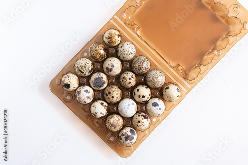 quail eggs in a plastic tray on a white background isolated, healthy food and delicacies, protein