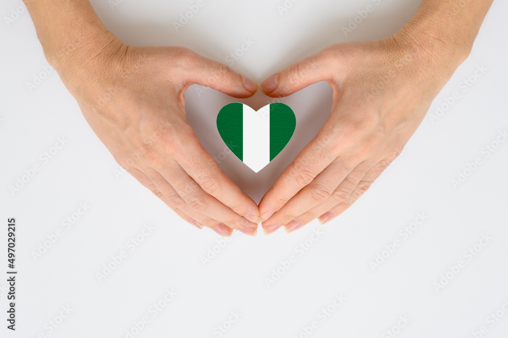 Fototapeta premium The national flag of Nigeria in female hands.