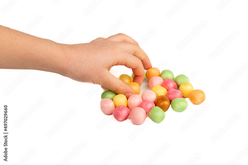 Child taking a candy on a white background Child taking a candy on a white background